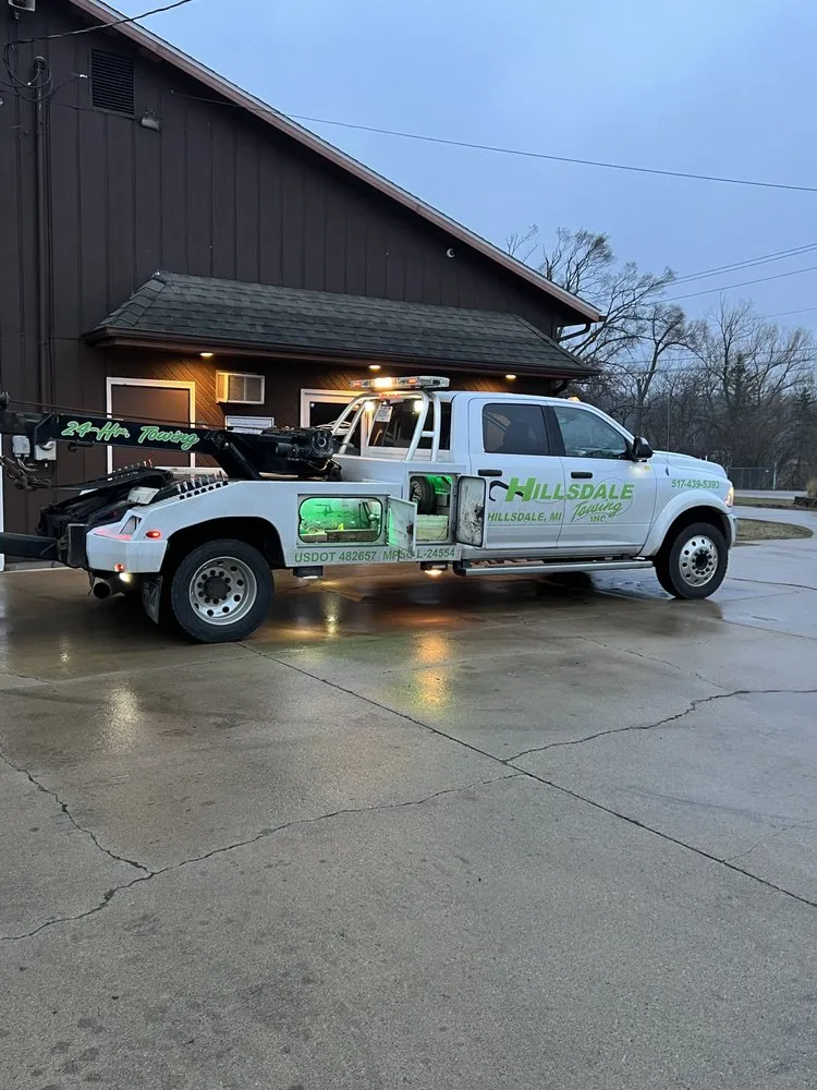 A Hillsdale Towing wrecker parked outside the shop